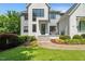 Charming entryway with modern black door, gray brick, and elegant landscaping, inviting you inside at 109 Greenock Ct, Cary, NC 27511