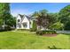 Beautiful home featuring a landscaped front yard, white brick, and black framed windows at 109 Greenock Ct, Cary, NC 27511