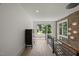 Well-lit hallway with hardwood floors, metal railings, and natural light from large windows at 109 Greenock Ct, Cary, NC 27511