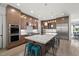 Kitchen features an island with seating, stainless steel appliances, hardwood floors, and modern cabinetry at 109 Greenock Ct, Cary, NC 27511