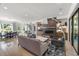 Open living room features a modern fireplace, hardwood floors, and a seamless flow to the dining room at 109 Greenock Ct, Cary, NC 27511