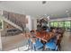 Open-concept living room with modern lighting, fireplace, hardwood floors, and staircase to the second floor at 109 Greenock Ct, Cary, NC 27511