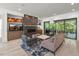 Bright living room with a modern fireplace, hardwood floors, neutral walls, and access to the patio at 109 Greenock Ct, Cary, NC 27511