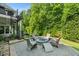 Stone patio with comfortable seating around a stylish fire pit, surrounded by greenery at 109 Greenock Ct, Cary, NC 27511