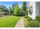 Lush side yard with vibrant green grass and manicured landscaping at 109 Greenock Ct, Cary, NC 27511