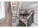 Staircase with contemporary railings leading to an open-concept living and dining area at 109 Greenock Ct, Cary, NC 27511