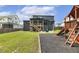Large backyard featuring a playground, screened in back porch, and firepit seating area at 1141 Duke Farm Dr, Wake Forest, NC 27587