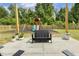 Backyard patio with black seating overlooks a playground, surrounded by lush greenery at 1141 Duke Farm Dr, Wake Forest, NC 27587