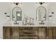 Double vanity bathroom with vessel sinks, arched mirrors, wood cabinets, and stylish decor at 1141 Duke Farm Dr, Wake Forest, NC 27587