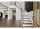 Bright foyer features white walls, staircase, paneled wall, and hardwood floors at 1141 Duke Farm Dr, Wake Forest, NC 27587