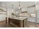 Spacious kitchen with a large island, quartz countertops, and custom cabinetry at 1141 Duke Farm Dr, Wake Forest, NC 27587