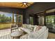 Relaxing covered porch with wood ceiling, comfortable seating, and outdoor ceiling fan at 1141 Duke Farm Dr, Wake Forest, NC 27587