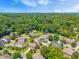An aerial view captures a picturesque neighborhood surrounded by lush greenery and mature trees at 118 Fox Run Ct, Durham, NC 27705