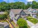 Aerial view of a beautiful home with a large yard, landscaping and long driveway at 118 Fox Run Ct, Durham, NC 27705