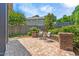 Private backyard patio features brick pavers, cozy seating and serene landscaping at 118 Fox Run Ct, Durham, NC 27705