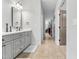 Stylish bathroom vanity with gray cabinets, dual mirrors, and modern fixtures at 118 Fox Run Ct, Durham, NC 27705
