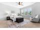 Bright bedroom featuring a ceiling fan, rocking chair, rug and windows at 118 Fox Run Ct, Durham, NC 27705