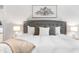 Comfortable bedroom featuring a plush bed, stylish headboard, bedside lamps, and modern decor at 118 Fox Run Ct, Durham, NC 27705