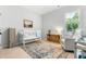 Cozy Bedroom with white crib, comfortable chair, and ample natural light at 118 Fox Run Ct, Durham, NC 27705