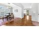 Bright dining area with hardwood floors, modern lighting, and a view into the updated kitchen at 118 Fox Run Ct, Durham, NC 27705