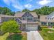 Charming two-story home with manicured lawn, landscaping, and a two-car garage with a concrete driveway at 118 Fox Run Ct, Durham, NC 27705