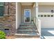 Inviting front entrance with stone steps and accents, plus a view of the two-car garage at 118 Fox Run Ct, Durham, NC 27705