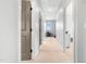 Bright hallway with neutral walls, carpet, and multiple doorways at 118 Fox Run Ct, Durham, NC 27705