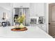 Bright kitchen island with quartz countertop, stainless appliances, and light wood floors at 118 Fox Run Ct, Durham, NC 27705