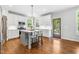 Modern kitchen with white cabinets, stainless steel appliances, a gray island, and hardwood floors at 118 Fox Run Ct, Durham, NC 27705