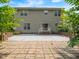 Beautiful backyard view of a two-story house with a brick and concrete patio area and a sliding glass door at 1209 Partington St, Wake Forest, NC 27587
