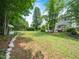 Expansive backyard with a mix of grass and natural landscaping, showcasing a serene and private outdoor space at 1209 Partington St, Wake Forest, NC 27587