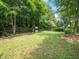 Large, grassy backyard enclosed by a wooden fence, providing privacy and a secure space for recreation at 1209 Partington St, Wake Forest, NC 27587
