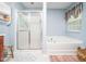 Bathroom features a glass enclosed shower and a soaking tub at 1209 Partington St, Wake Forest, NC 27587
