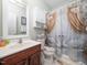 Bathroom featuring swan themed shower curtain, vanity with sink, and functional wall storage at 1209 Partington St, Wake Forest, NC 27587
