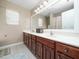 Bathroom with double sinks, wood cabinets and a large mirror at 1209 Partington St, Wake Forest, NC 27587