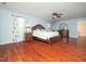 Spacious bedroom features a ceiling fan, hardwood floors, and floral curtains at 1209 Partington St, Wake Forest, NC 27587