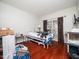 Bright bedroom with hardwood floors featuring a hospital bed and natural light through the window at 1209 Partington St, Wake Forest, NC 27587