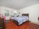 Bedroom with hardwood floors, desk, and two windows at 1209 Partington St, Wake Forest, NC 27587