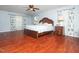 Spacious bedroom features a ceiling fan, hardwood floors, and floral curtains at 1209 Partington St, Wake Forest, NC 27587