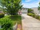 Inviting two-story home with a driveway and tree, plus attractive landscaping at 1209 Partington St, Wake Forest, NC 27587