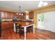 Well-lit kitchen with an island and access to the backyard at 1209 Partington St, Wake Forest, NC 27587
