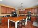 Spacious kitchen featuring wooden cabinets, a large wooden island, and modern appliances at 1209 Partington St, Wake Forest, NC 27587