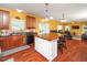 Open kitchen with a large island with seating and warm, inviting colors at 1209 Partington St, Wake Forest, NC 27587
