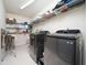 Bright laundry room with shelving and black washer and dryer at 1209 Partington St, Wake Forest, NC 27587