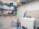 Bright laundry room with shelving, utility sink and laundry basket at 1209 Partington St, Wake Forest, NC 27587