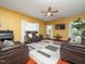 Comfortable living room with a ceiling fan, stylish rug, and plenty of leather seating at 1209 Partington St, Wake Forest, NC 27587