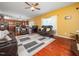 Open concept living room flowing to the kitchen and showcasing hardwood floors and comfortable seating at 1209 Partington St, Wake Forest, NC 27587