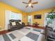 Cozy living room boasts a ceiling fan, a comfortable leather sofa set and natural light at 1209 Partington St, Wake Forest, NC 27587