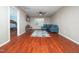 Open living area with hardwood floors, blue leather sofa and a view into another bedroom at 1209 Partington St, Wake Forest, NC 27587