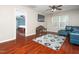 Open living area with hardwood floors, blue leather sofa and a view into another bedroom at 1209 Partington St, Wake Forest, NC 27587
